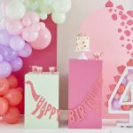 Kit de décoration d'anniversaire thème dinosaure rose, avec des assiettes, gobelets, ballons et accessoires mignons pour une fête pleine d'aventure et de douceur.